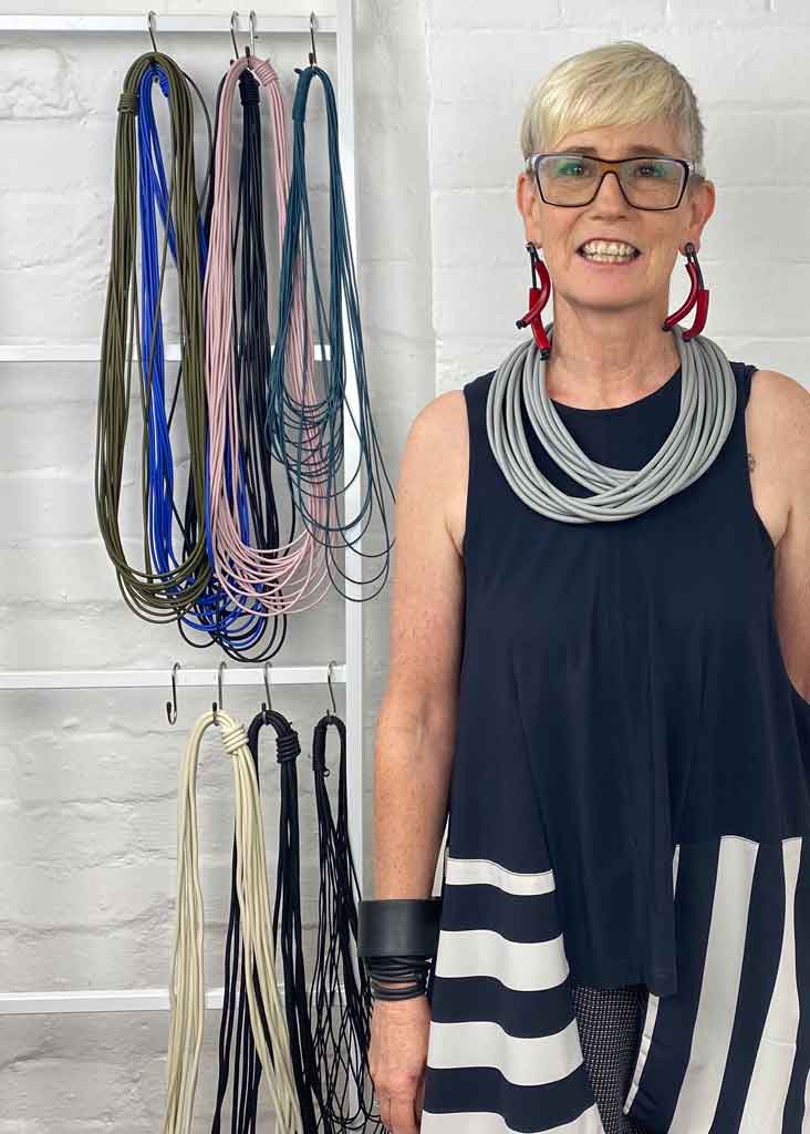 woman wearing a long grey rubber necklace