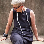 woman wearing a long black and white rod necklace