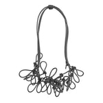 grey statement rubber necklace on a white background