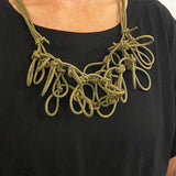 woman wearing a green statement necklace