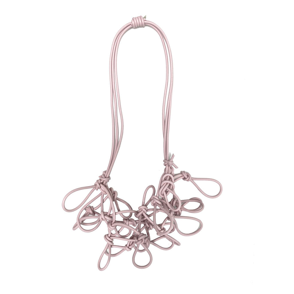 pink statement necklace on a white background