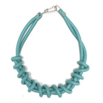 teal twist necklace on a white background