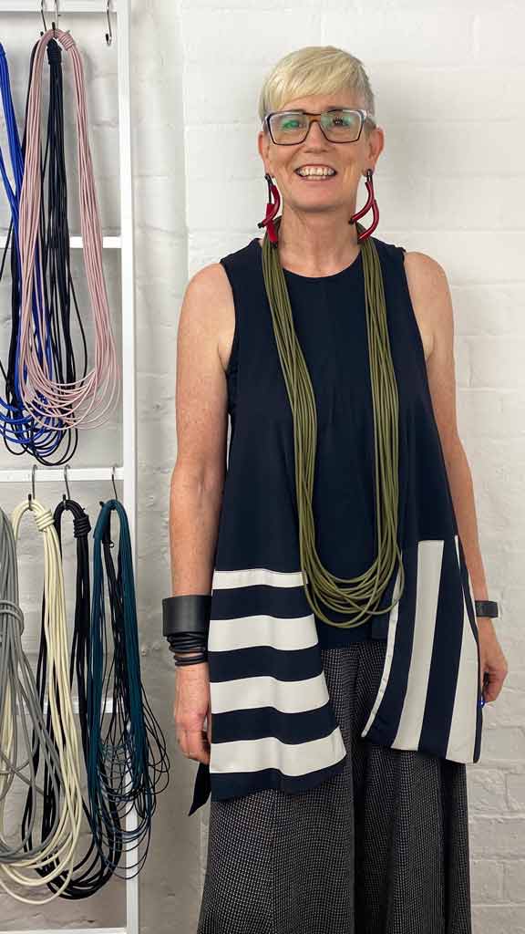 woman wearing olive green long necklace