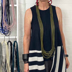 woman wearing olive green long necklace