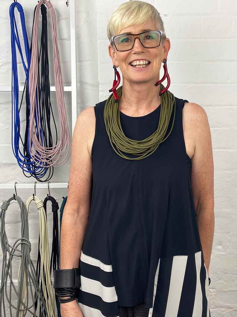 woman wearing olive green necklace