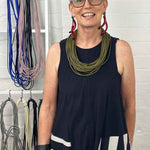 woman wearing olive green necklace