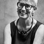 Green rubber earrings made with sterling silver. Bold, fun design. Worn by the designer Rowan Shaw