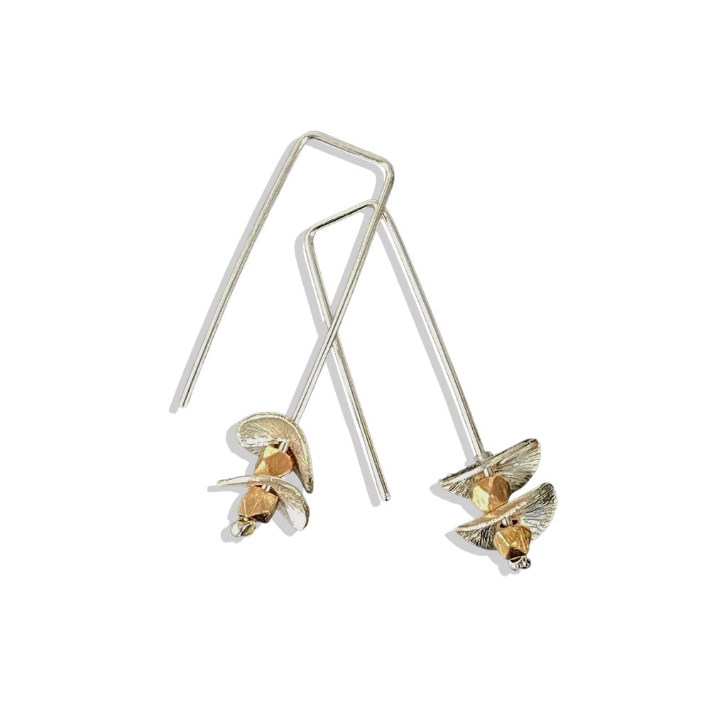 silver earrings with round silver disks on a white background