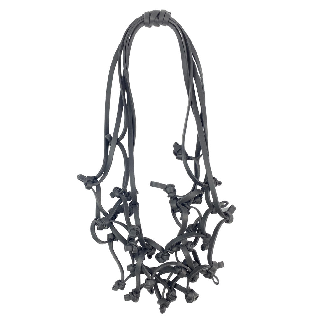 black knotted rubber necklace on a white background