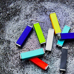 colorful tower earrings on a dark background