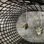 silver drop earrings with silver square disks on a net backdrop