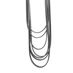 black layered rubber necklace on a white background
