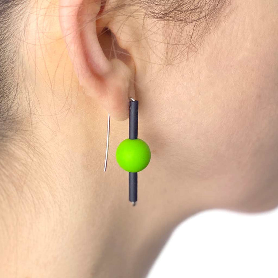 Green rubber earrings made with sterling silver. Bold, fun design.