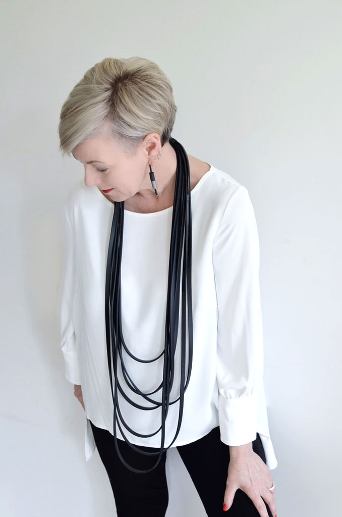 woman wearing a long layered rubber necklace