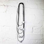 white star necklace on a white brick wall background