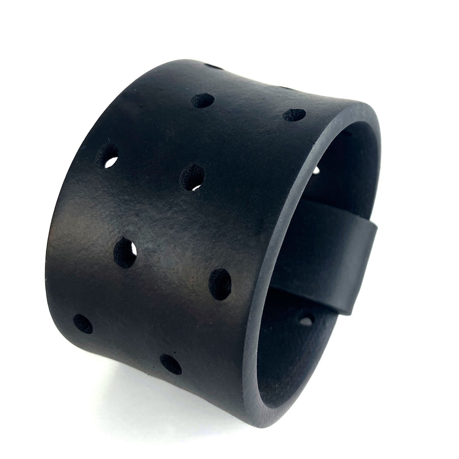 wide rubber bangle with holes on a white background