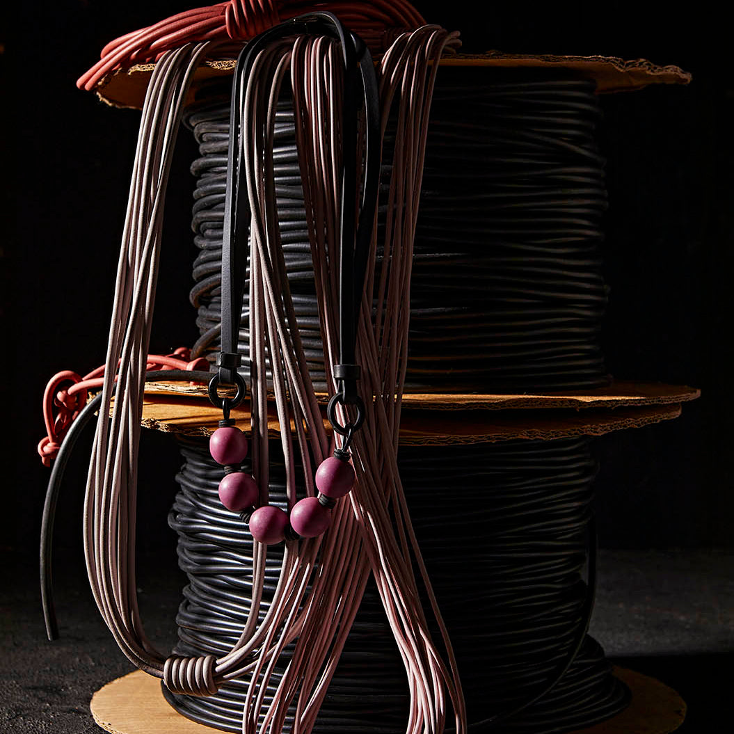 A styled photo of Frank Ideas rubber jewellery and necklaces