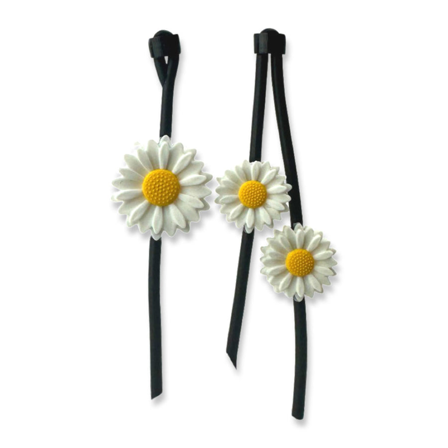 asymmetric daisy earrings on a white background