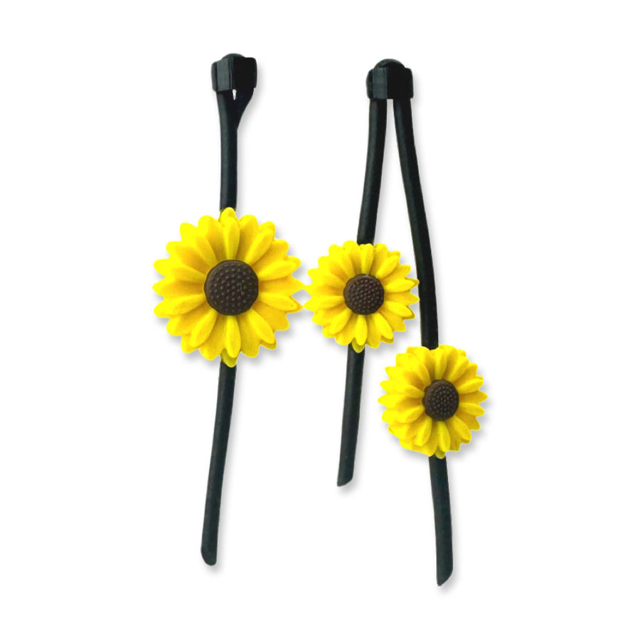 asymmetric sunflower earrings on a white background