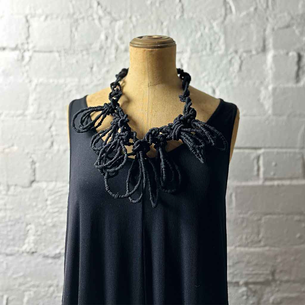 black textile necklace on a mannequin
