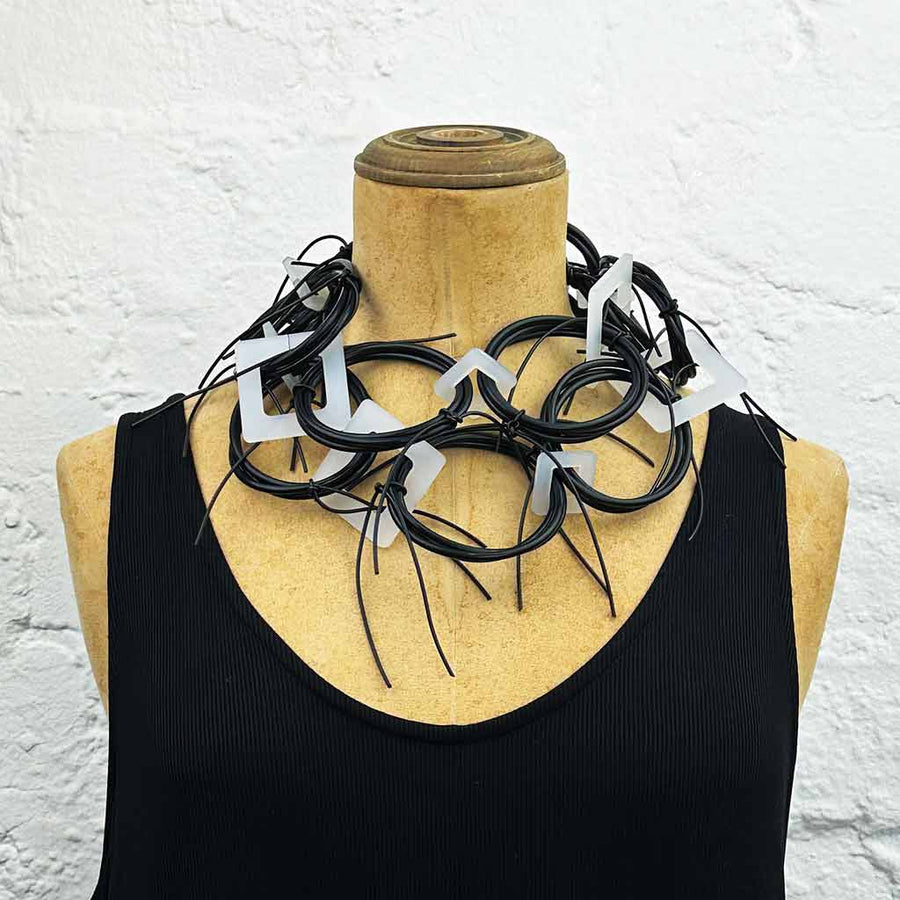 Long chaotic necklace recycled materials black and white