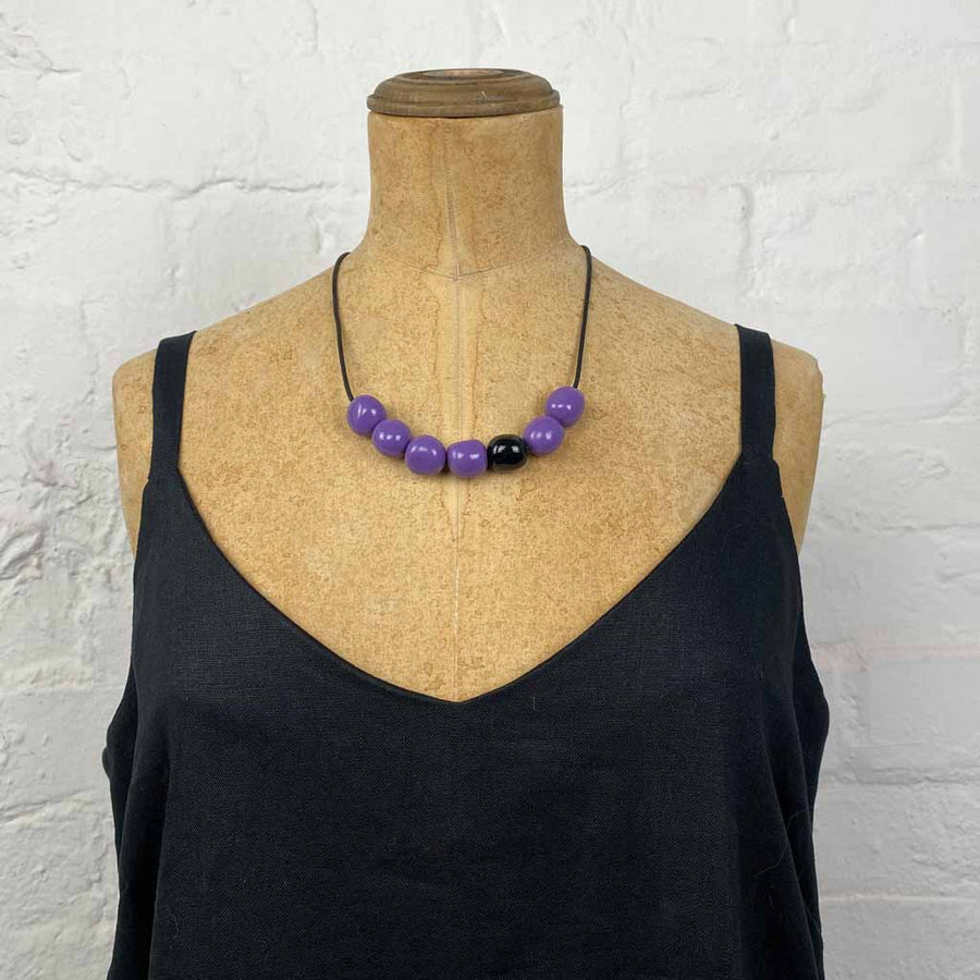 Resin pebble necklace- glossy purple with one black