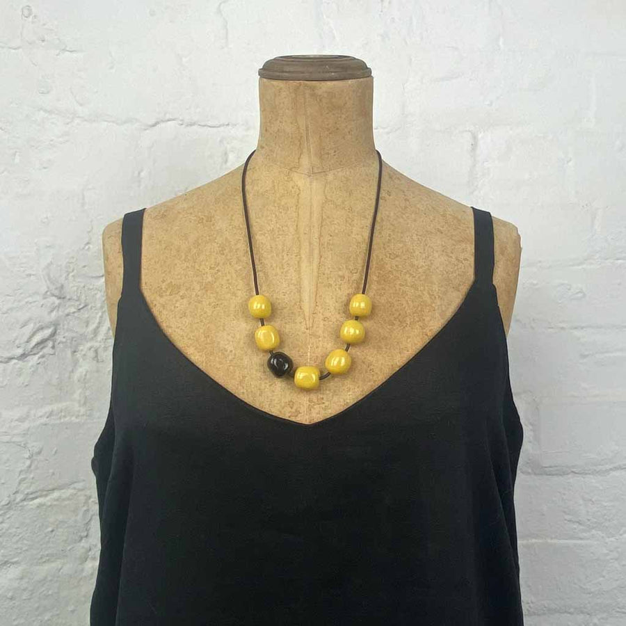Resin pebble necklace- glossy lemon with one black