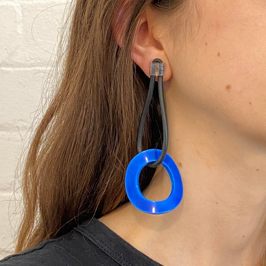 woman wearing blue drop earrings