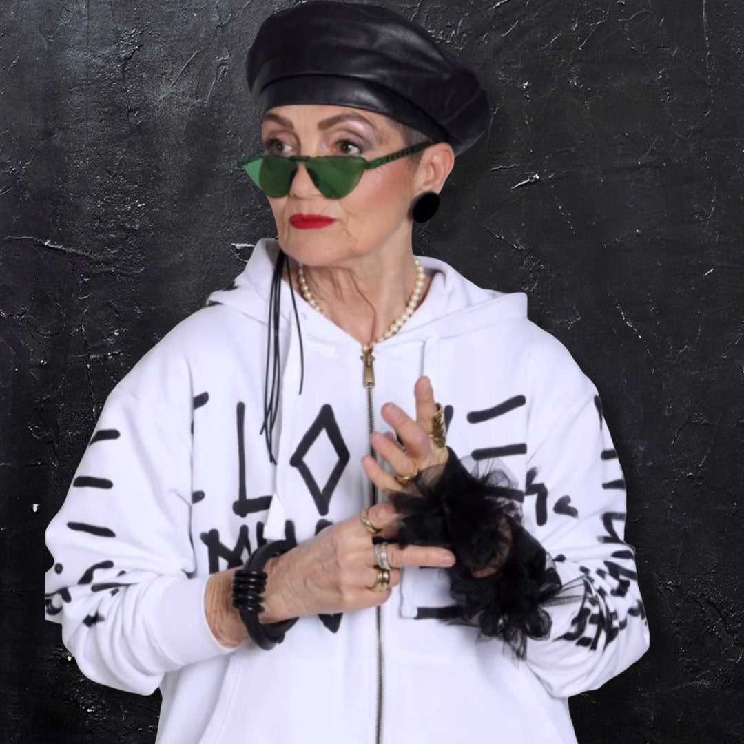 Woman wearing black Fantasy Bangles with tulle detail, styled with a white printed hoodie.
