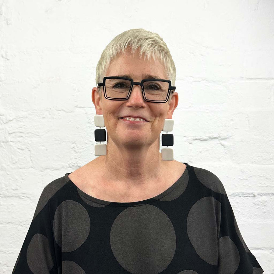 Rowan, owner of Frank Ideas wearing Black and White square drop earrings.