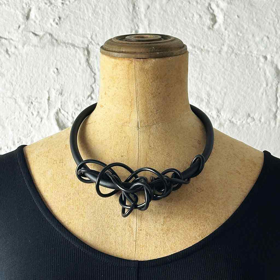 black tangled necklace on a mannequin
