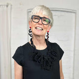 black textile necklace worn by a woman