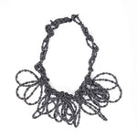 black and white stripe textile necklace on a white background