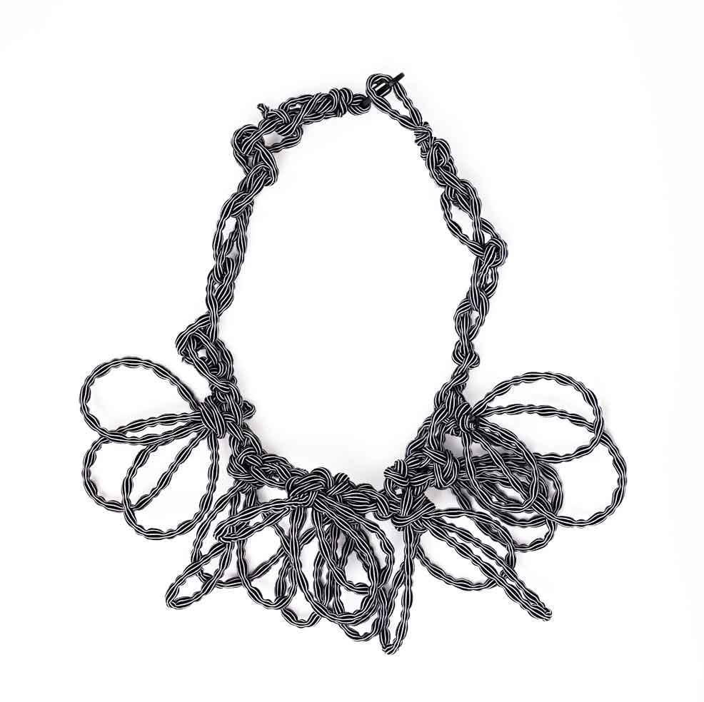 black and white stripe textile necklace on a white background
