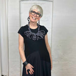 black and white stripe textile necklace worn by a woman