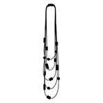 Multi strand necklace with black plastic beads on a mannequin