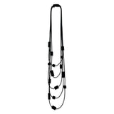 Multi strand necklace with black plastic beads on a mannequin