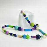 bold colour long  rubber bead necklace on Aalto vase