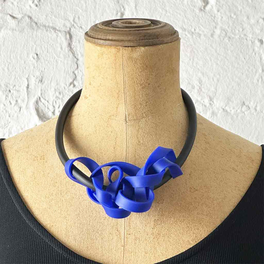 blue rubber tangled necklace on a mannequin