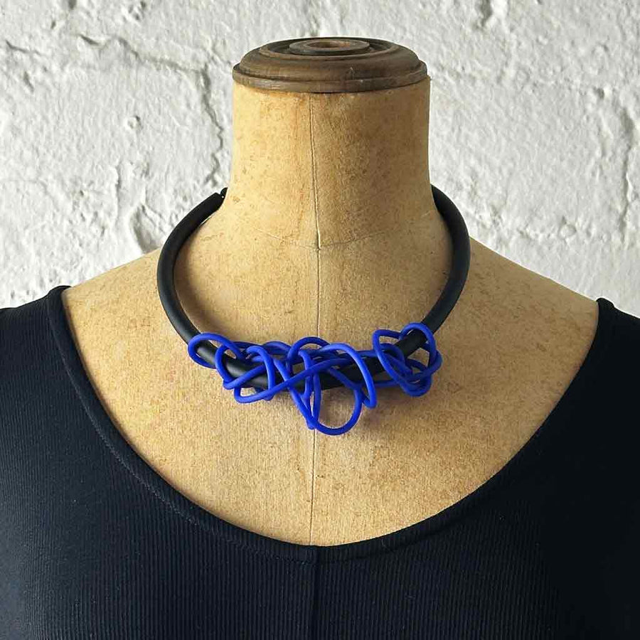 blue tangled necklace on a mannequin