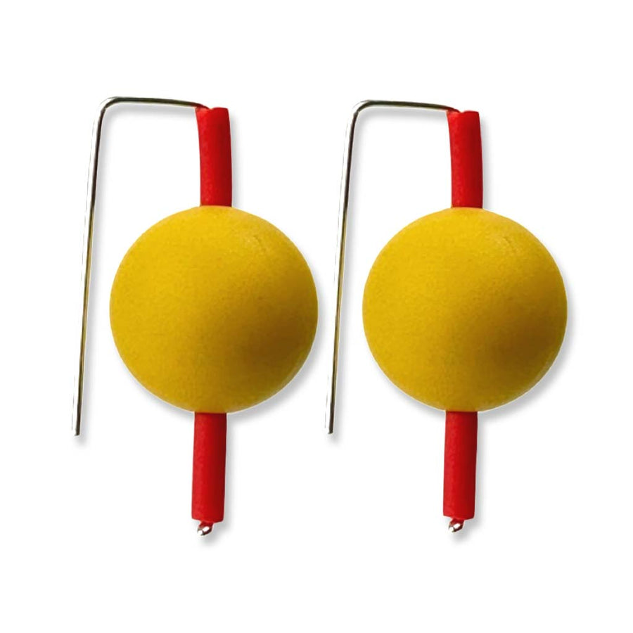 mustard-coloured and red supersized earrings on a white background