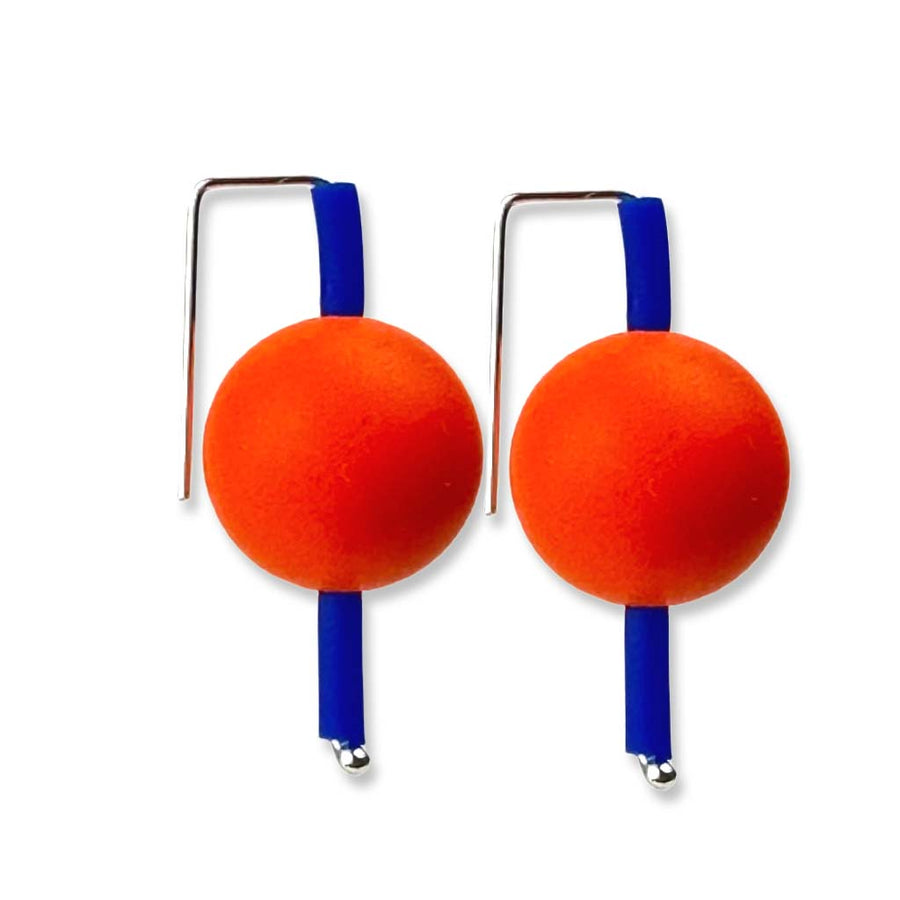 orange and blue supersized earrings on a white background