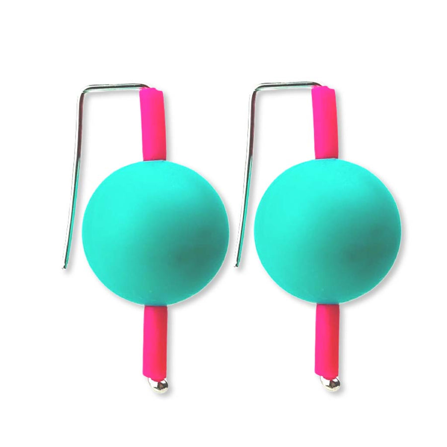 pink and teal supersized earrings on a white background