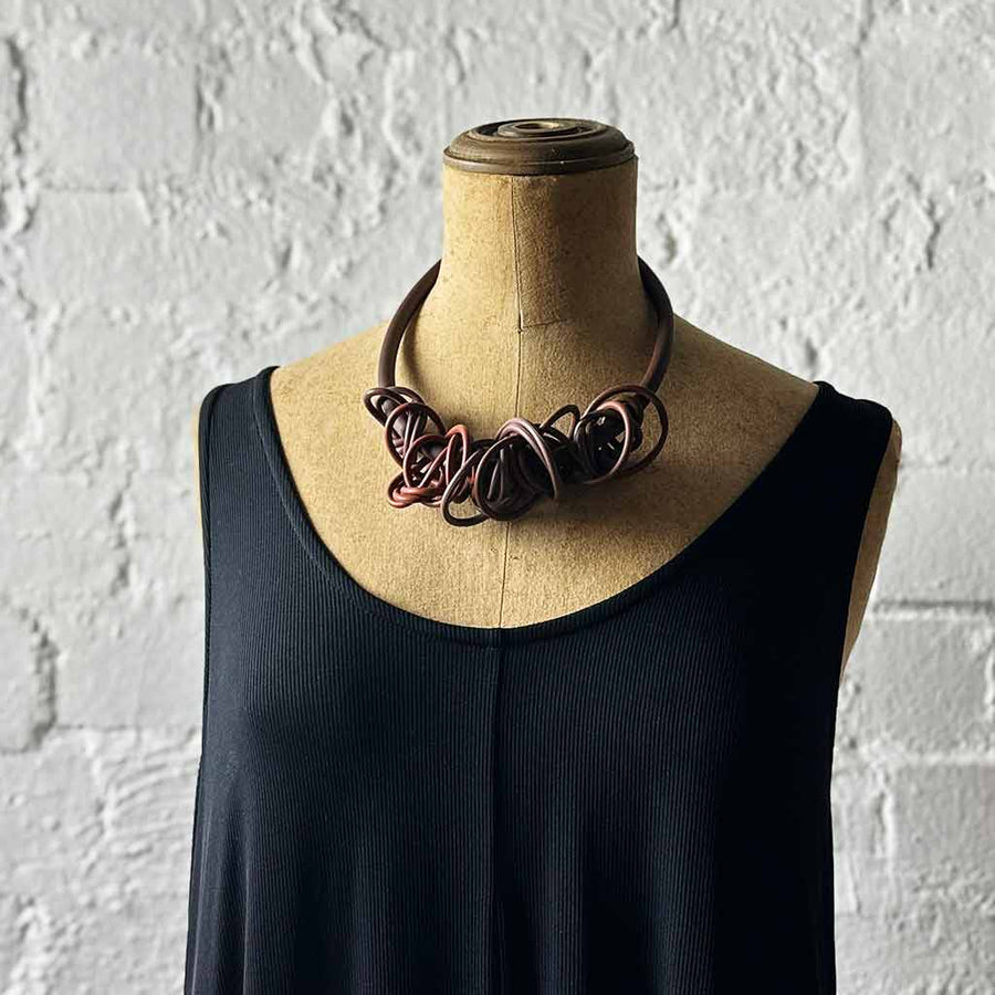 brown tangled necklace on a mannequin