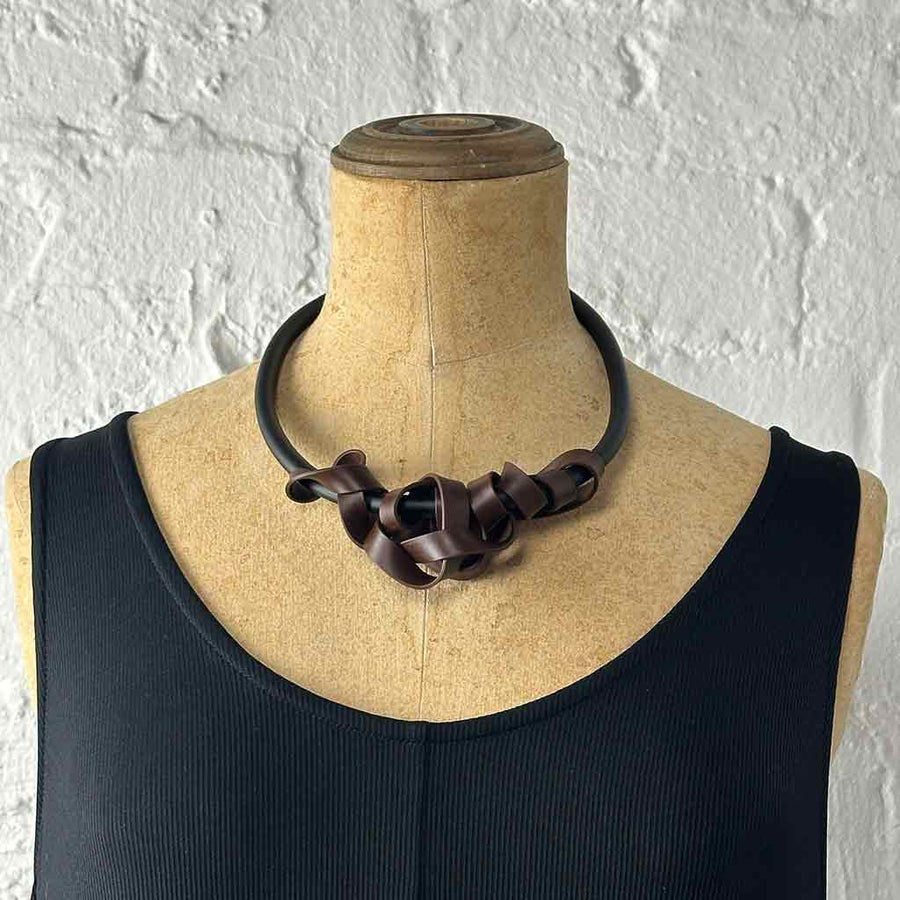 brown rubber tangled necklace on a mannequin