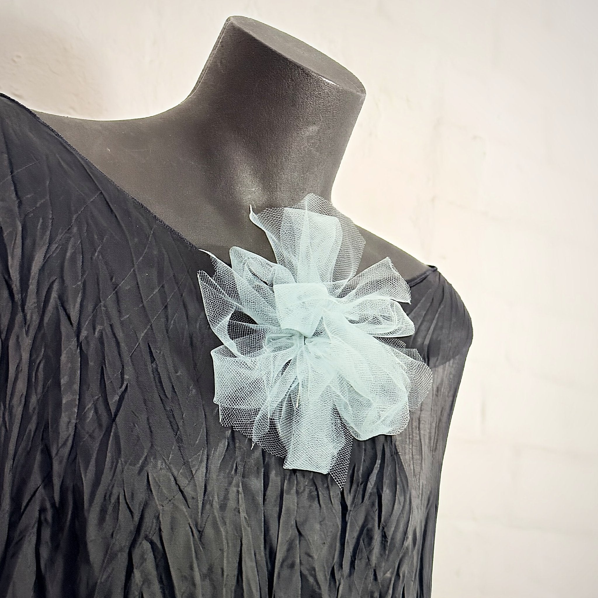 Fantasy Brooch in Sea Foam worn on a black dress – rubber and tulle statement brooch, handmade by Frank Ideas