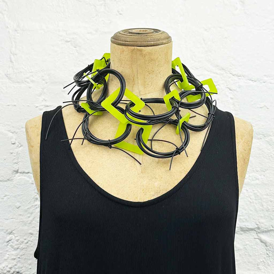 Long chaotic necklace recycled materials with lime green squares and black rubber o rings