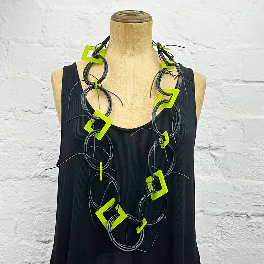 Long chaotic necklace recycled materials with lime green squares and black rubber o rings