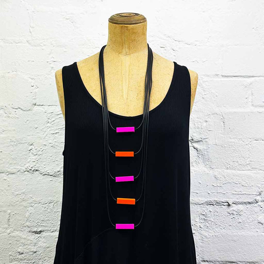 Long drop necklace with colourful blocks on a mannequin 