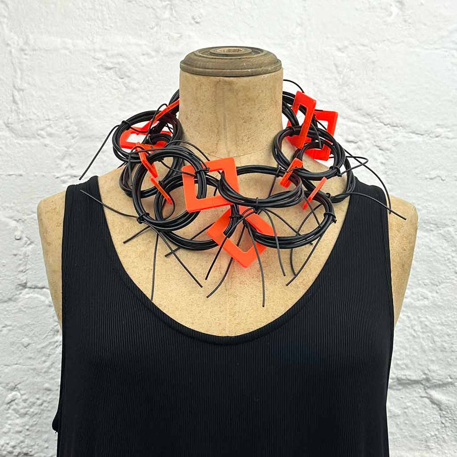 Adaptable necklace using recycled materials. Black and Orange